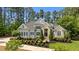 Stunning stone and gray two-story home with professionally landscaped front yard and manicured lawn at 14013 Wallberman Dr, Wake Forest, NC 27587
