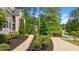 Two-story home with lush landscaping, a curved driveway, and mature trees providing ample shade at 14013 Wallberman Dr, Wake Forest, NC 27587