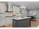 Kitchen featuring white cabinets, an island with pendant lighting, stainless steel appliances, and hardwood floors at 14013 Wallberman Dr, Wake Forest, NC 27587