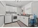 A well-organized laundry room is shown, equipped with a washer, dryer, and built-in cabinetry at 14013 Wallberman Dr, Wake Forest, NC 27587