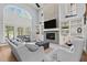 Inviting living room with fireplace, built-in bookshelves, and high ceilings, perfect for relaxation at 14013 Wallberman Dr, Wake Forest, NC 27587