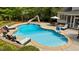 Inviting in-ground pool with a slide, lounge chairs, and mature trees at 14013 Wallberman Dr, Wake Forest, NC 27587