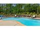 Beautiful in-ground pool with brick retaining wall, professional landscaping, and plenty of seating at 14013 Wallberman Dr, Wake Forest, NC 27587