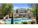 Backyard with a large, sparkling pool, a waterslide, patio seating, and mature landscaping at 14013 Wallberman Dr, Wake Forest, NC 27587
