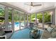 Relaxing sunroom featuring a ceiling fan, comfortable seating, and views of the pool and backyard at 14013 Wallberman Dr, Wake Forest, NC 27587