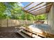 A view of the pergola covered patio and fenced backyard at 1402 W Lakewood Ave, Durham, NC 27707
