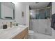 Updated bathroom with modern vanity, marble countertop, glass shower doors, and sleek fixtures at 1402 W Lakewood Ave, Durham, NC 27707