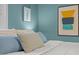 A close up of some blue accent pillows on a white bedspread at 1402 W Lakewood Ave, Durham, NC 27707