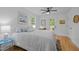 This bedroom has hardwood floors, a door leading outside, and a ceiling fan at 1402 W Lakewood Ave, Durham, NC 27707
