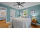 This bedroom has a ceiling fan, a door, and hardwood flooring at 1402 W Lakewood Ave, Durham, NC 27707