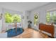 Dining area with a round table, surrounded by windows offering natural light and backyard views at 1402 W Lakewood Ave, Durham, NC 27707