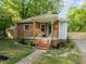 Cozy brick home with a welcoming front porch, landscaped yard, and stone pathway at 1402 W Lakewood Ave, Durham, NC 27707