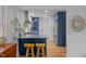Bright kitchen boasts navy cabinets, a marble counter, stainless appliances, and wood floors at 1402 W Lakewood Ave, Durham, NC 27707