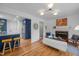 Spacious living area with hardwood floors, an open layout, and stylish blue kitchen at 1402 W Lakewood Ave, Durham, NC 27707