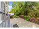 Covered back patio is surrounded by lush landscaping including various shrubs and flowering plants at 141 Hilda Grace Ln, Cary, NC 27519