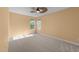 Comfortable bedroom features neutral carpet, a modern ceiling fan, and two windows providing ample natural light at 141 Hilda Grace Ln, Cary, NC 27519