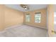Cozy bedroom with neutral carpet, a modern ceiling fan, and two windows providing ample natural light at 141 Hilda Grace Ln, Cary, NC 27519
