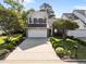 Beautiful two-story home with lush landscaping, a long driveway, and a well-manicured lawn at 141 Hilda Grace Ln, Cary, NC 27519