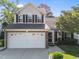 Charming two-story home featuring a two-car garage, brick accents, and well-maintained landscaping at 141 Hilda Grace Ln, Cary, NC 27519