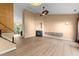 Open living room with fireplace, wooden floors, statement art and bright lighting at 141 Hilda Grace Ln, Cary, NC 27519