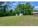 Lush backyard showcasing storage sheds and the home's expansive outdoor space at 141 Montesino Dr, Raleigh, NC 27603