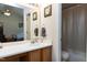 Bathroom featuring a single sink vanity, a well-lit mirror, and a shower/tub combination for convenient bathing at 141 Montesino Dr, Raleigh, NC 27603