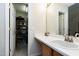 Bathroom vanity with sink, mirror, and view of walk in closet at 141 Montesino Dr, Raleigh, NC 27603