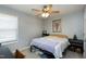 Cozy bedroom featuring a comfortable bed, ceiling fan, natural light, and functional furniture for a relaxing space at 141 Montesino Dr, Raleigh, NC 27603