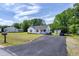 Charming single-story home with a well-maintained front yard, driveway, and a covered parking area at 141 Montesino Dr, Raleigh, NC 27603