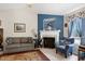 Cozy living room featuring a fireplace, plush seating, and ceiling fan at 141 Montesino Dr, Raleigh, NC 27603