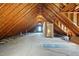 Spacious unfinished attic with exposed wood beams, skylights, and a single window at 1429 Raybon Dr, Wendell, NC 27591