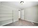 Neutral bedroom featuring built-in closet shelving and carpeted floors at 1429 Raybon Dr, Wendell, NC 27591