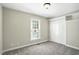 Bedroom featuring a closet with sliding doors, a window, and neutral carpeted flooring at 1429 Raybon Dr, Wendell, NC 27591