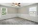 Bedroom with carpet flooring, ceiling fan, wainscotting, and natural light at 1429 Raybon Dr, Wendell, NC 27591