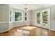 Bright dining area featuring large windows, a chandelier, and access to the outdoors at 1429 Raybon Dr, Wendell, NC 27591