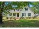Charming home with white siding, blue shutters, inviting porch and mature landscaping at 1429 Raybon Dr, Wendell, NC 27591