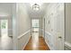 Bright hallway featuring hardwood floors, white trim and doors leading to other rooms at 1429 Raybon Dr, Wendell, NC 27591