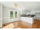 Eat-in kitchen featuring a center island, white cabinets, and French doors that bring in natural light at 1429 Raybon Dr, Wendell, NC 27591