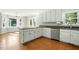 Kitchen featuring white cabinets, granite counters, stainless steel dishwasher, and hardwood floors at 1429 Raybon Dr, Wendell, NC 27591