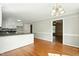 Spacious kitchen with hardwood floors, white cabinets, and an open layout perfect for entertaining at 1429 Raybon Dr, Wendell, NC 27591