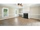 Inviting living room with a cozy fireplace, built-in shelving, and lots of natural light at 1429 Raybon Dr, Wendell, NC 27591