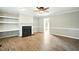 Comfortable living room with a fireplace and shelving, seamlessly connecting to other areas at 1429 Raybon Dr, Wendell, NC 27591