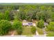 An aerial view of a residential home with solar panels and a backyard pool surrounded by lush greenery at 149 Baldwin Dr, Durham, NC 27712