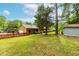 Brick home with a well-maintained lawn, storage shed, and a charming red picket fence in the backyard at 149 Baldwin Dr, Durham, NC 27712