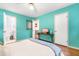 Teal bedroom offering a peaceful retreat, featuring hardwood floors and a view into the connected bathroom at 149 Baldwin Dr, Durham, NC 27712