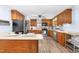 Kitchen featuring wood cabinets, stainless steel appliances, and a bar seating area at 149 Baldwin Dr, Durham, NC 27712