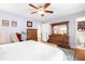 Main bedroom with a cozy bed, wood floors, and an ensuite bathroom at 149 Baldwin Dr, Durham, NC 27712