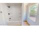 Modern bathroom features a tub-shower combo with matte black hardware and a large window at 1622 Julian Oakley Rd, Rougemont, NC 27572