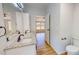 Bright bathroom featuring double sinks with granite counters and vinyl floors at 1622 Julian Oakley Rd, Rougemont, NC 27572