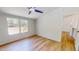 Bright bedroom with wood-look flooring, ceiling fan, and windows at 1622 Julian Oakley Rd, Rougemont, NC 27572